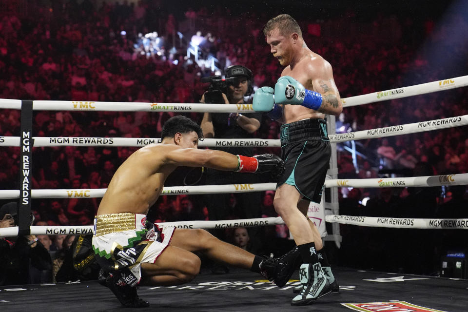 Canelo Alvarez knocks down Jaime Munguia in a super middleweight title fight Saturday, May 4, 2024, in Las Vegas. (AP Photo/John Locher)