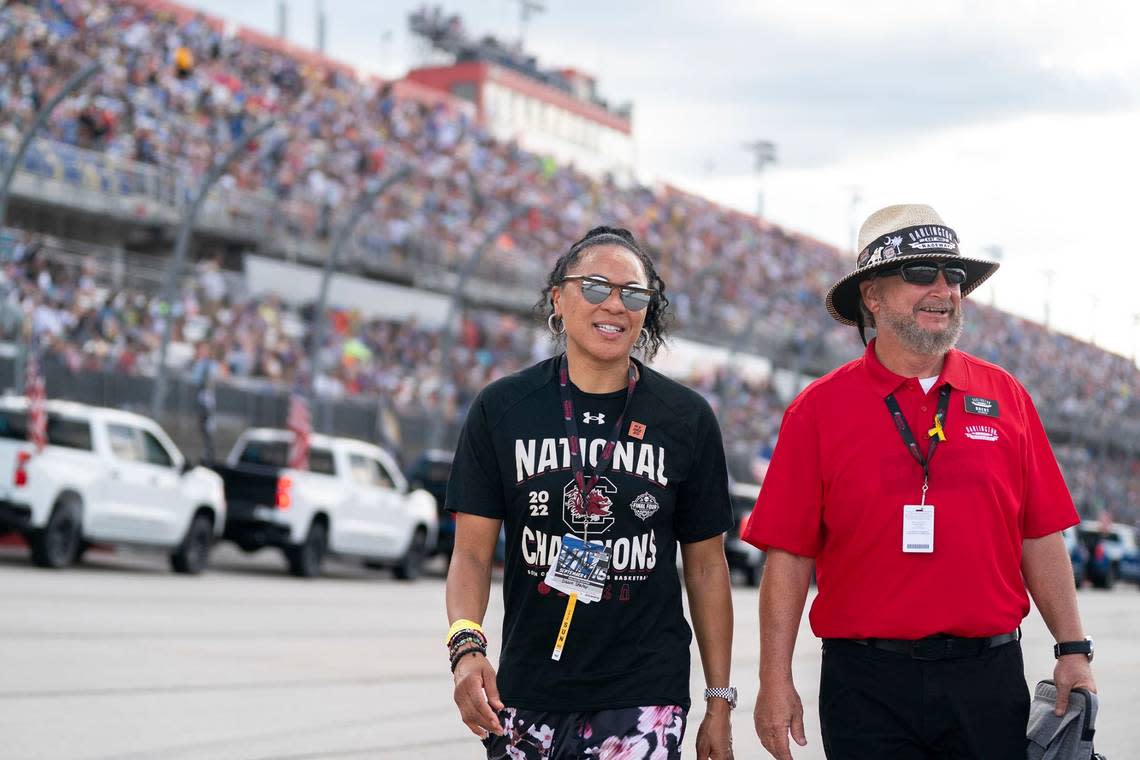 University of South Carolina women’s basketball coach Dawn Staley, left, walks on the track at Darlington Raceway with Brent Childress before the Southern 500 NASCAR auto race Sunday, Sept. 4, 2022, in Darlington, S.C. Staley was the honorary pace car driver. (AP Photo/Sean Rayford)