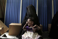 <p>In this Feb. 12, 2018 photo, Sawda Mohammed Khalil holds her malnourished daughter as they wait for treatment at the al-Khoukha Hospital in Yemen. Doctors estimate 40 percent of the children in the town suffer from malnutrition. Barefoot children fill the center’s corridors, many visibly emaciated, some with malaria or cholera. Some can barely stand. (Photo: Nariman El-Mofty/AP) </p>