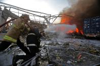 Lebanese firefighters extinguish fire at the scene of an explosion at the port in the capital Beirut on August 4, 2020. - Two huge explosion rocked the Lebanese capital Beirut, wounding dozens of people, shaking buildings and sending huge plumes of smoke billowing into the sky. Lebanese media carried images of people trapped under rubble, some bloodied, after the massive explosions, the cause of which was not immediately known. (Photo by STR / AFP) (Photo by STR/AFP via Getty Images)