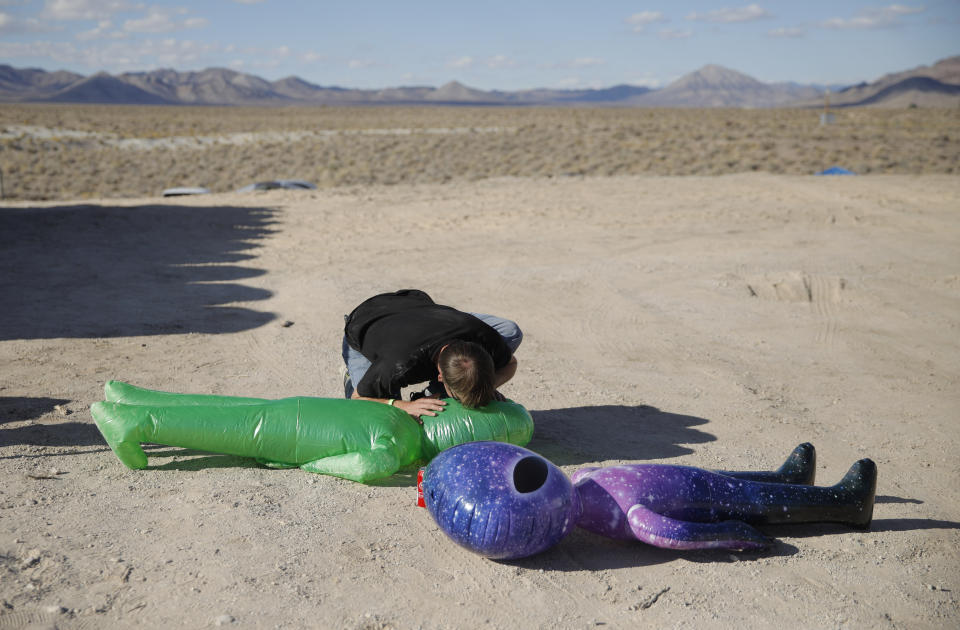 Marshall Bishop blows up an inflatable alien at the Storm Area 51 Basecamp event Friday, Sept. 20, 2019, in Hiko, Nev. "It's the perfect stat to have this in. They turn everything into a party," Bishop said about the event, which was inspired by the "Storm Area 51" internet hoax. (AP Photo/John Locher)