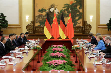 China's President Xi Jinping (2nd L) and German Chancellor Angela Merkel (2nd R) attend a meeting at the Great Hall of the People in Beijing, China, May 24, 2018. REUTERS/Jason Lee/Pool