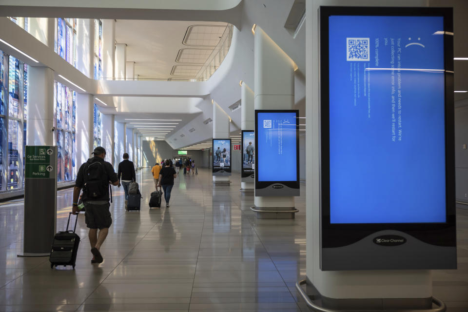 Screens show a blue error message on the departures floor at New York's LaGuardia Airport on Friday, July 19, 2024, after a faulty CrowdStrike update caused a major internet outage for computers running Microsoft Windows.  (AP Photo/Yuki Iwamura)