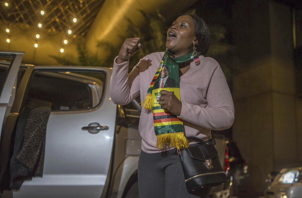 A ZANU-PF supporter celebrates the victory of Zimbabwean President Emmerson Mnangagwa at the conference center where the results were announced, in Harare, Zimbabwe, Friday Aug. 3, 2018. Mnangagwa won election Friday with just over 50 percent of the ballots as the ruling party maintained control of the government in the first vote since the fall of longtime leader Robert Mugabe. (AP Photo/Mujahid Safodien)