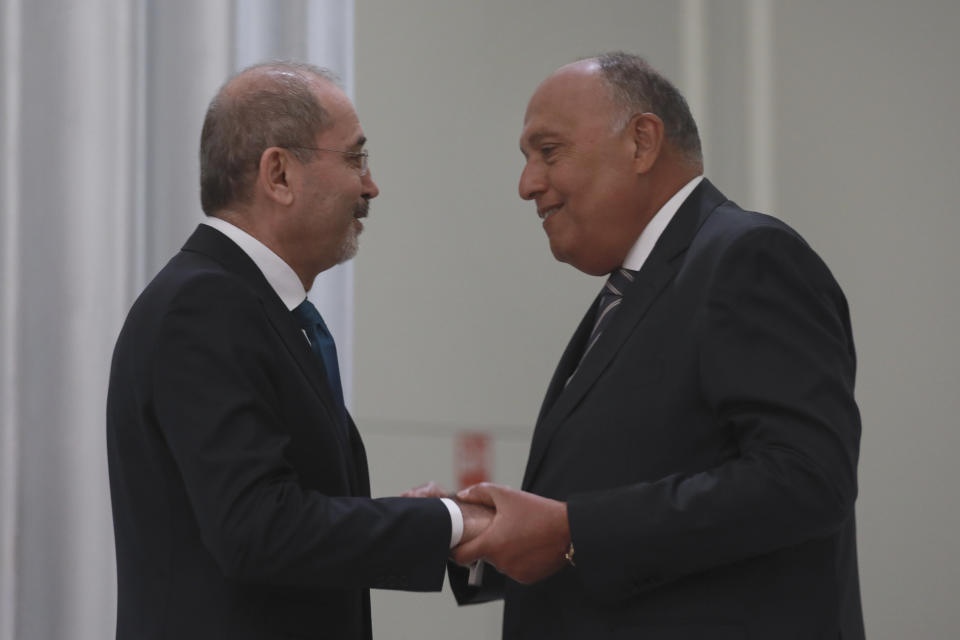Jordanian Foreign Minister Ayman Safadi, left, shakes hands with his Egyptian counterpart Sameh Shoukry during a regional consultative meeting held in Amman, Jordan , Monday, May 1, 2023. Regional leaders are meeting in Jordan to discuss Syria's return to the Arab fold and a Jordanian proposal to reach a "political solution" to the Syrian conflict. The talks, attended by the top diplomats of Jordan, Syria, Saudi Arabia, Iraq and Egypt, kicked off Monday with a meeting between Jordanian Foreign Minister Ayman Safadi and Syrian Foreign Minister Faisal Mekdad. (AP Photo/Raad Adayleh)