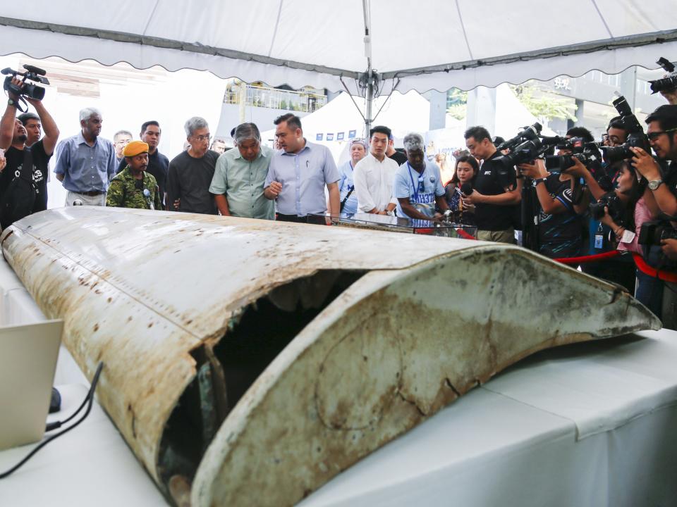 Malaysian Minister of Transport, Anthony Loke (C) looks at the Wing flap found on Pemba Island, Tanzania which has been identified a missing part of Malaysia Airlines Flight MH370 through unique part numbers traced to 9M-MRO during a commemoration event to mark the 5th anniversary of the missing Malaysia Airlines MH370 flight in Kuala Lumpur, Malaysia on March 03, 2019.