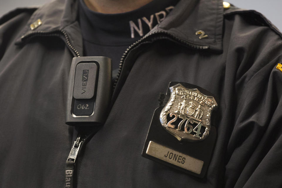 FILE - In this Dec. 3, 2014 file photo, New York Police Department officer Joshua Jones wears a VieVu body camera on his chest during a news conference in New York. The NYPD, the nation's largest police department, will begin rolling out body cameras by the end of this month, after resolving the thorniest issues on when to turn them on and off, and how long video will be kept. (AP Photo/Mark Lennihan, File)