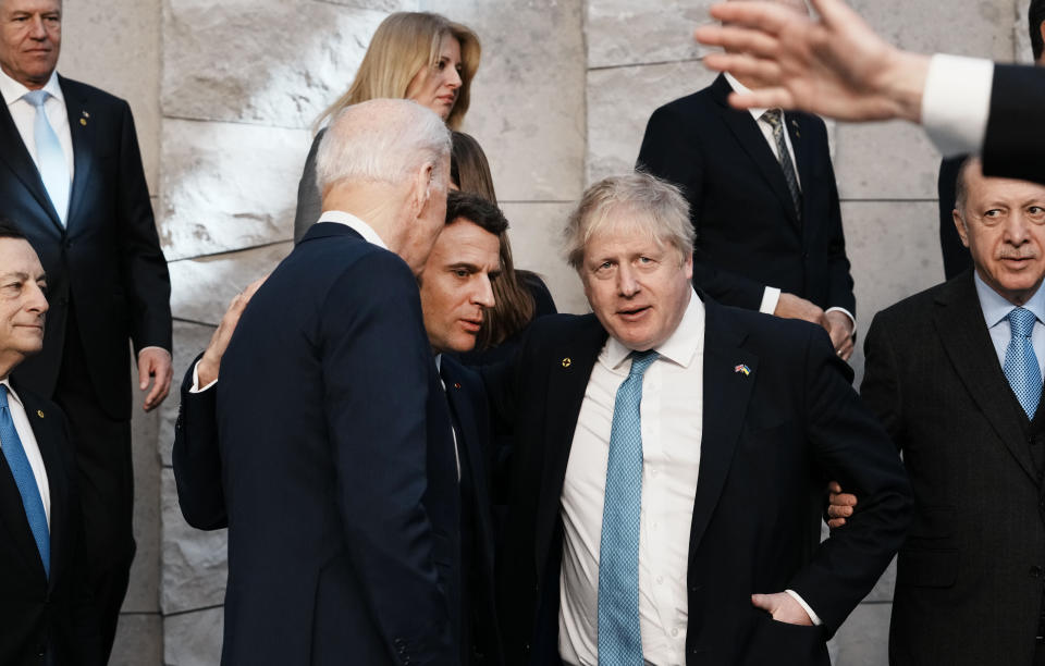 French President Emmanuel Macron, center, puts his arm on the shoulder of U.S. President Joe Biden, center left, and British Prime Minister Boris Johnson as they speak at a group photo during an extraordinary NATO summit at NATO headquarters in Brussels, Thursday, March 24, 2022. This was the year war returned to Europe, and few facets of life were left untouched. Russia’s invasion of its neighbor Ukraine unleashed misery on millions of Ukrainians, shattered Europe’s sense of security, ripped up the geopolitical map and rocked the global economy. The shockwaves made life more expensive in homes across Europe, worsened a global migrant crisis and complicated the world’s response to climate change. (AP Photo/Thibault Camus)