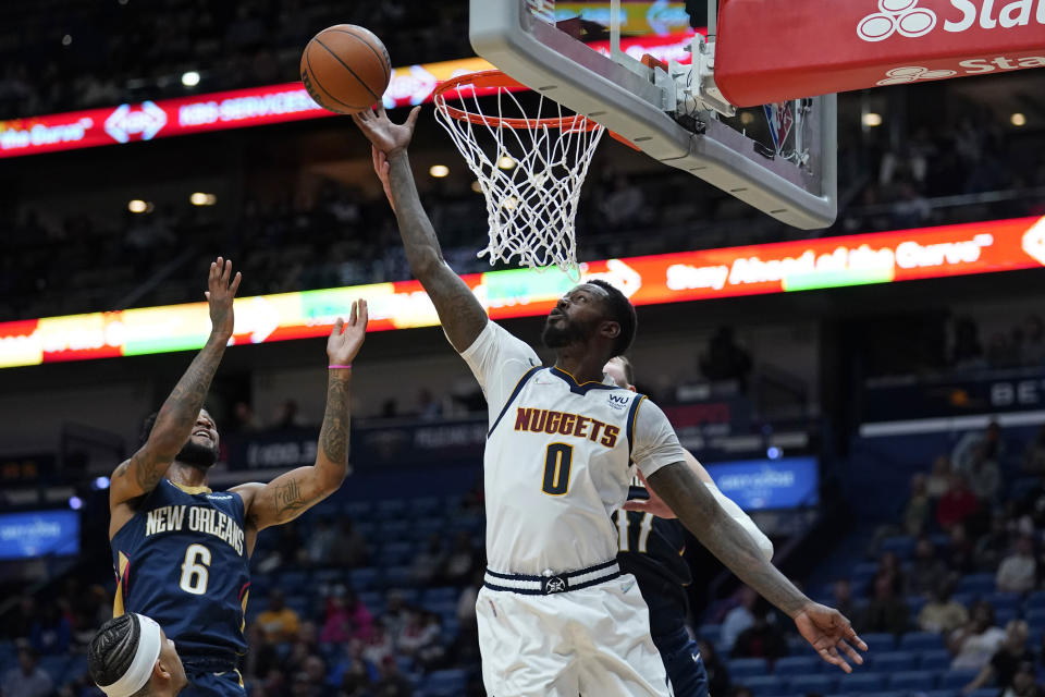 Denver Nuggets forward JaMychal Green (0) goes to the basket against New Orleans Pelicans guard Nickeil Alexander-Walker (6) in the first half of an NBA basketball game in New Orleans, Wednesday, Dec. 8, 2021. (AP Photo/Gerald Herbert)