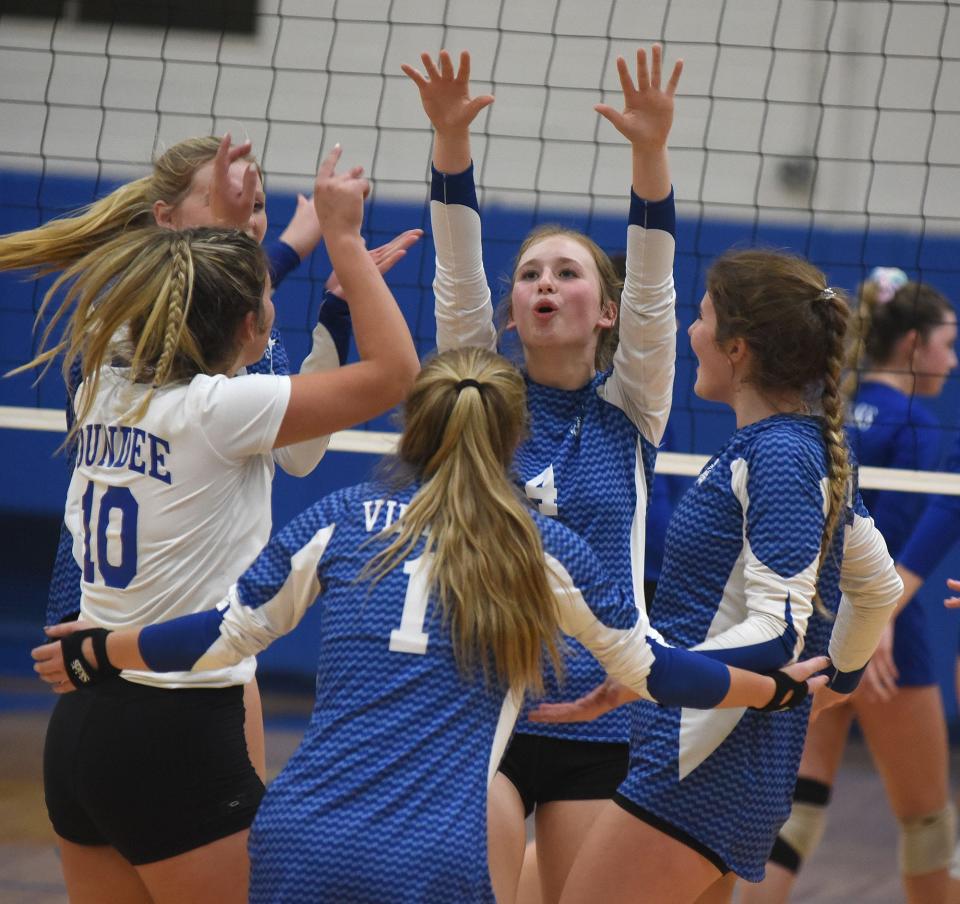 Kennedy Irwin of Dundee reacts with her teammates after she stuff the ball back against Ida in the Division 2 District semifinals Thursday.