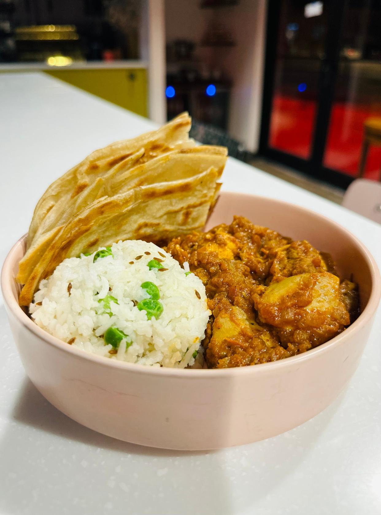 Frying Lotus' chicken gravy served with brown butter paratha and peas pulao