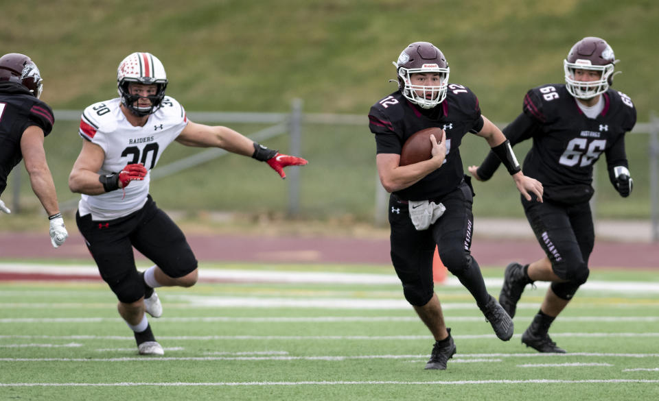 FILE - Morningside NCAA college football quarterback Joe Dolincheck carries the ball against Northwestern College in the NAIA semifinals at Elwood Olsen Stadium in Sioux City, Iowa, Saturday, Dec. 4, 2021. Dolincheck led a group of Morningside College seniors that climbed Pike's Peak this summer. He'll try to lead them back to the mountaintop of NAIA football this fall. (Jesse Brothers/Sioux City Journal via AP, File)