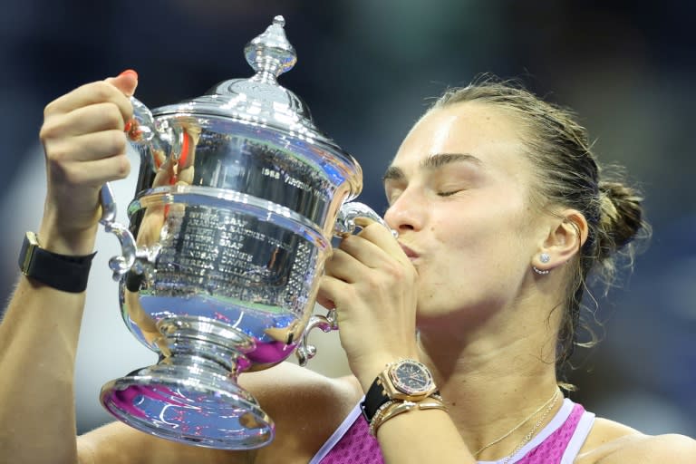 Champion: Aryna Sabalenka kisses the trophy after defeating Jessica Pegula in the US Open final (CHARLY TRIBALLEAU)