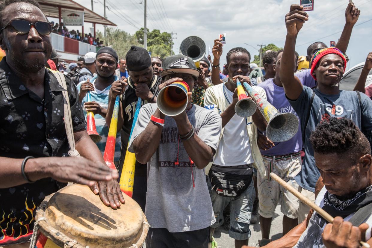 Supporters of former president Jean-Bertrand Aristide celebrated his return from medical treatment in Cuba (AFP via Getty Images)