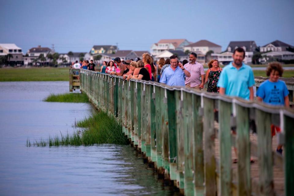 Visitors to the Veterans Pier along the Murrells Inlet Waterfront a King Tide. Aug. 11, 2021.