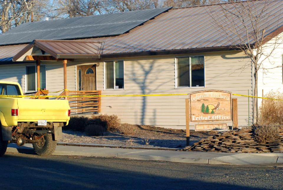 Crime scene tape surrounds the tribal headquarters of the Cedarville Rancheria Friday, Feb. 21, 2014 in Alturas, Calif., where police say an eviction hearing turned deadly as a woman who once served as a tribal leader allegedly opened fire, killing four people and critically wounding two others in a gun and knife attack. Cherie Lash Rhoades, a former chairwoman of Cedarville Rancheria, was taken into custody after the bloody attack at the tribal office Thursday afternoon, Alturas police chief Ken Barnes said in area media reports. (AP Photo/Jeff Barnard)