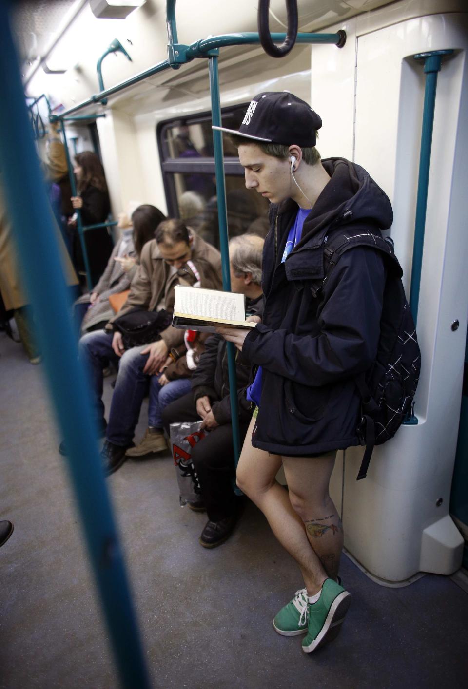 A passenger without his pants reads a book as he uses a subway train during the "No Pants Subway Ride" event in Sofia January 12, 2014. The event is an annual flash mob and occurs in different cities around the world, according to its organisers. REUTERS/Stoyan Nenov (BULGARIA - Tags: SOCIETY ENTERTAINMENT)