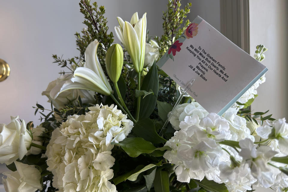 A floral arrangement sent to the late U.S. Senator Bob Graham's family from President Joe Biden and first lady Jill sits on display at the historic Old Capitol in Tallahassee, Fla., Friday, April 26, 2024, where his body lies in state. Graham, who died April 16, served as Florida governor before his election to the U.S. Senate. (AP Photo/Brendan Farrington)