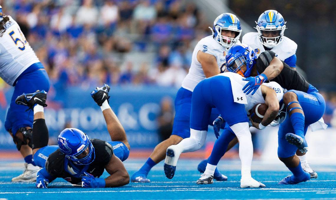 Boise State defensive end Ahmed Hassanein chases San Jose State quarterback Chevan Cordeiro into the waiting arms of linebacker Andrew Simpson for a Bronco sack in the first half Oct. 7 at Albertsons Stadium.