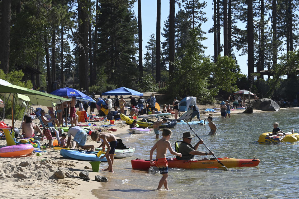 Visitors to Lake Tahoe fill a section of Sand Harbor in the Lake Tahoe Nevada State Park in Incline Village, Nev., Monday, July 17, 2023. Tourism officials at Lake Tahoe were surprised, and a bit standoffish, when a respected international travel guide included the iconic alpine lake straddling the California line on a list of places to stay away from this year because of the harmful ecological effects of overtourism. (AP Photo/Andy Barron)