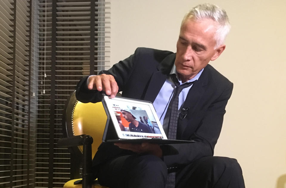 El periodista de Univision, Jorge Ramos, muestra el video que hizo sobre personas comiendo de las sobras de la basura en Caracas. El video habría enfurecido a Maduro al punto de que se levantó de la silla 17 minutos después de comenzar la entrevista en Miraflores. (AP Photo)