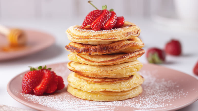 fluffy eggnog pancakes with strawberries