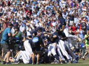 Mississippi's Jack Washburn, right, leaps on top of the team pile in celebration of their 4-2 victory over Oklahoma in Game 2 of the NCAA College World Series baseball finals, Sunday, June 26, 2022, in Omaha, Neb. Mississippi defeated Oklahoma 4-2 to win the championship. (AP Photo/Rebecca S. Gratz)