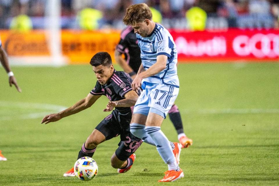 Inter Miami midfielder Diego Gómez (20) attempts to shield the ball from Sporting Kansas City midfielder Jake Davis (17) in the first half of an MLS game at GEHA Field at Arrowhead Stadium on Saturday, April 13, 2024, in Kansas City.