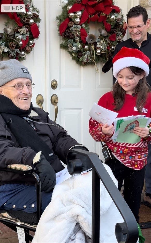 Layla Leuthy Peck presents Joseph Gagliardi of Newtown Township with 100 birthday cards for his 100th birthday Friday as Gagliardi's son-in-law, Bob Thomas, watches.