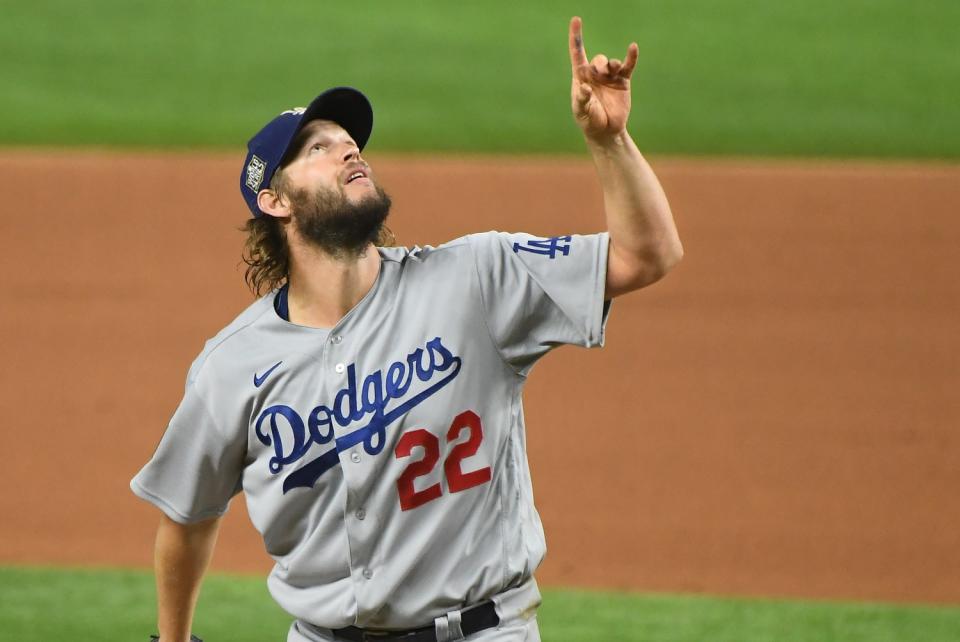 Dodgers pitcher Clayton Kershaw points to the sky as a Rays hitter pops-up.