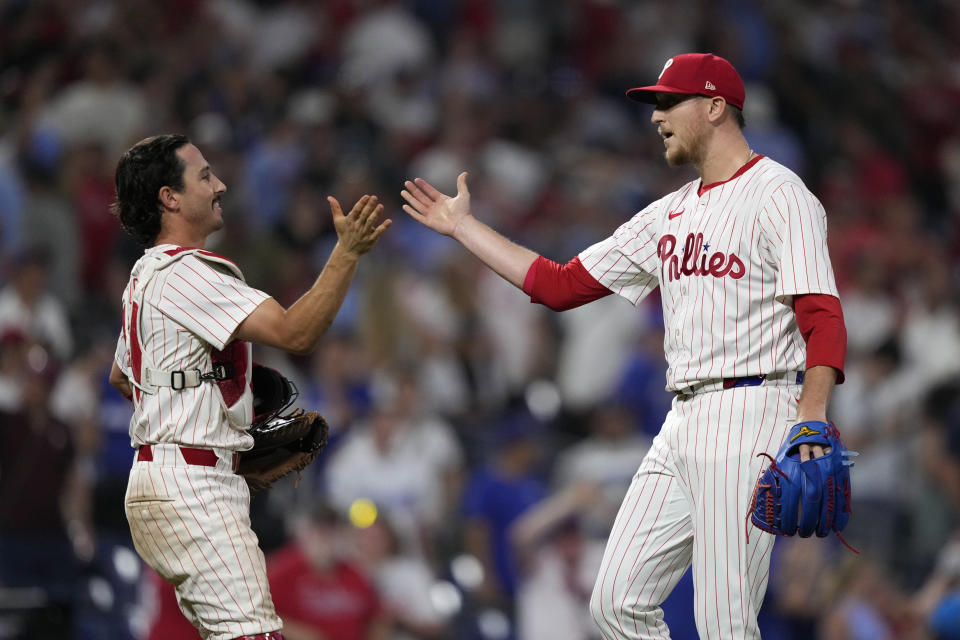 Philadelphia Phillies' Garrett Stubbs, left, and Jeff Hoffman celebrate after the Phillies won a baseball game against the Los Angeles Dodgers, Wednesday, July 10, 2024, in Philadelphia. (AP Photo/Matt Slocum)