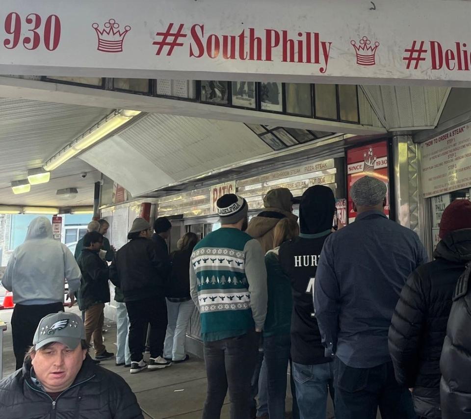 Patrons in Eagles garb line up for cheesesteaks at Pat's in South Philadelphia.