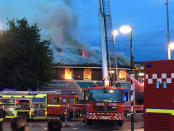 Firefighters battle a fire at a department store in Chingford, London, Britain August 23, 2017 in this still image obtained from social media. Jonathan Boyce via REUTERS