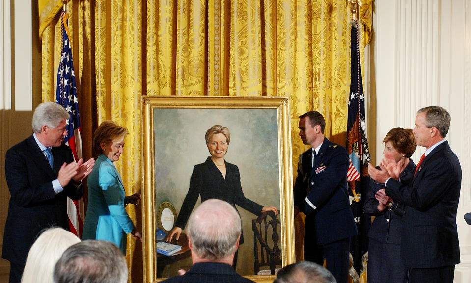 FILE - Former President Bill Clinton, left, and President George W. Bush and first lady Laura Bush, right, applaud as former first lady Sen. Hillary Clinton's portrait is unveiled during a ceremony at the White House, June 14, 2004. (AP Photo/Dennis Cook, File)