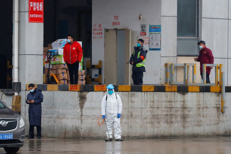 FILE PHOTO: A worker in PPE stands in Baishazhou market during a visit of World Health Organization (WHO) team tasked with investigating the origins of the coronavirus (COVID-19) pandemic, in Wuhan