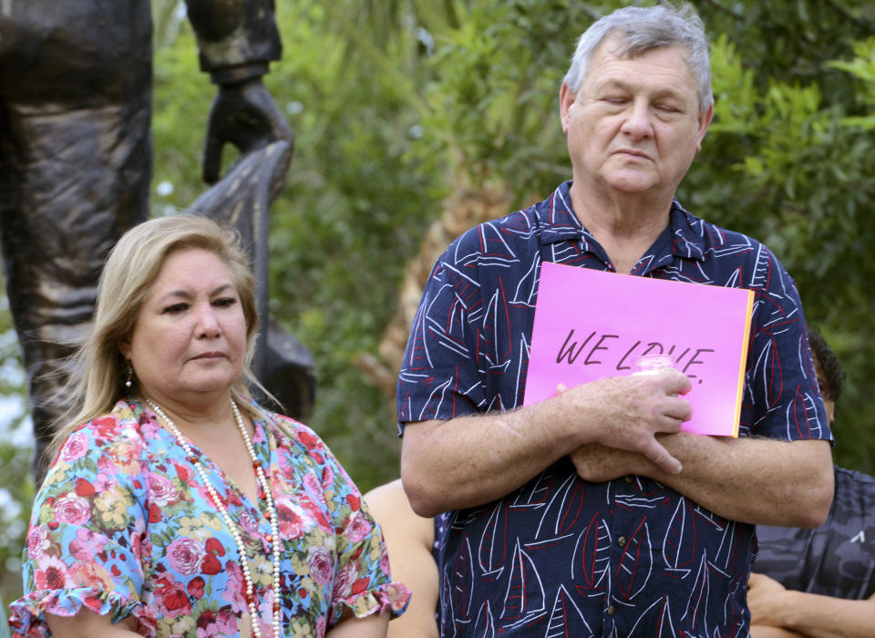 People attend a vigil at Linear Park in Brownsville, Texas, Monday, May 8, 2023. An SUV driver who killed eight people when he slammed into a group waiting at a bus stop in Brownsville was charged with manslaughter, police said Monday as investigators tried to determine if the crash was intentional. (Miguel Roberts/The Brownsville Herald via AP)