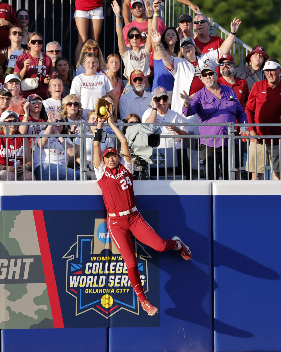 Oklahoma's Jayda Coleman catches a fly ball hit by Florida State's Kalei Harding during the third inning of the second game of the NCAA Women's College World Series softball championship series Thursday, June 8, 2023, in Oklahoma City. (AP Photo/Nate Billings)