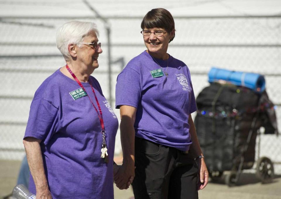 Chris Delany, left, who founded Loaves & Fishes and Sister Libby Fernandez, right, leads a parade to celebrate the organization’s 30th anniversary in 2013. Delany, 90, died Sept. 3 from natural causes. Her memorial service is scheduled for Thursday, Sept. 28.