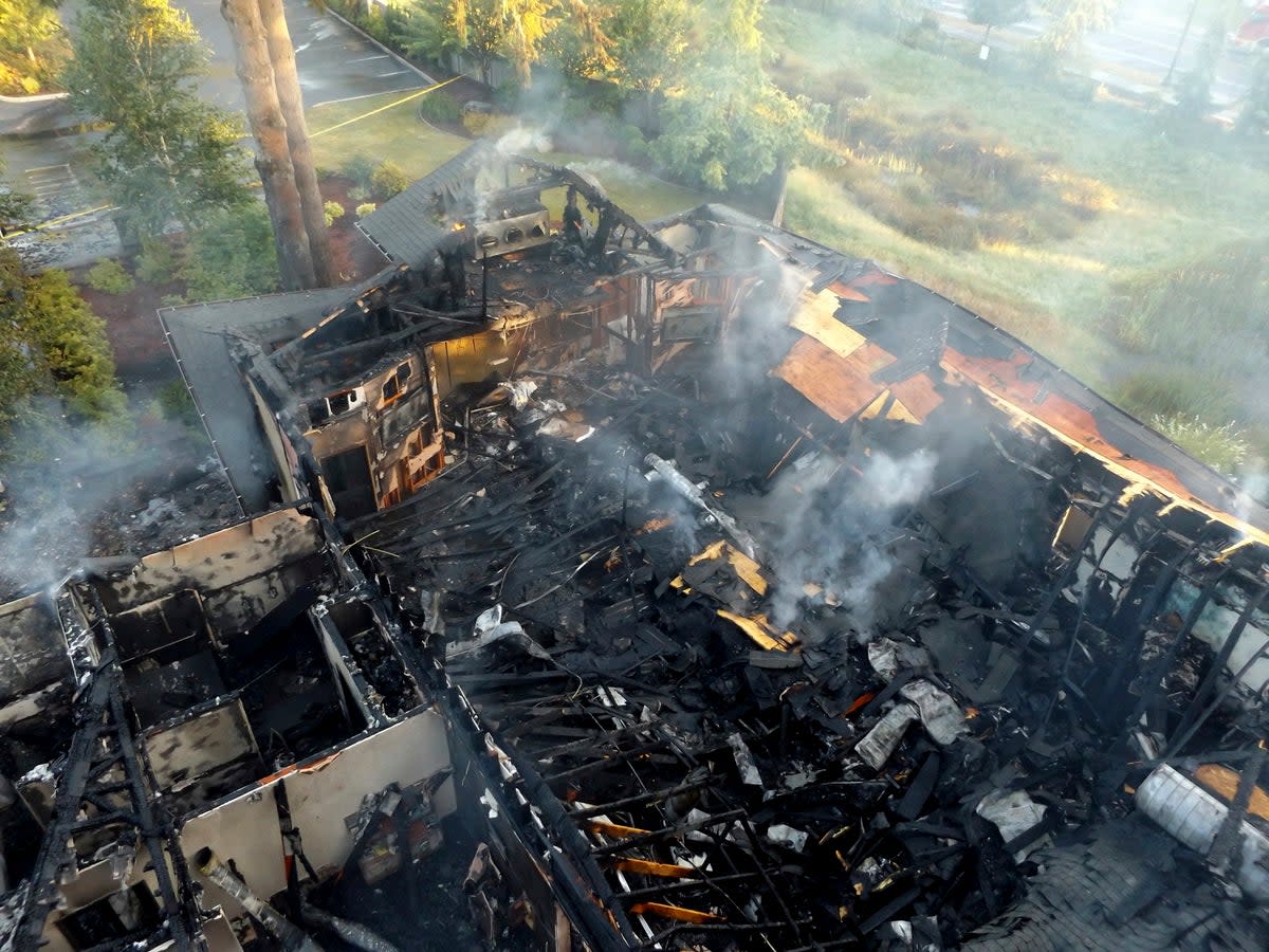 This photo provided by Olympia Fire Department shows damage from an arson that destroyed the Jehovah’s Witness kingdom hall in Olympia, Washington, on 3 July 2018 (AP)