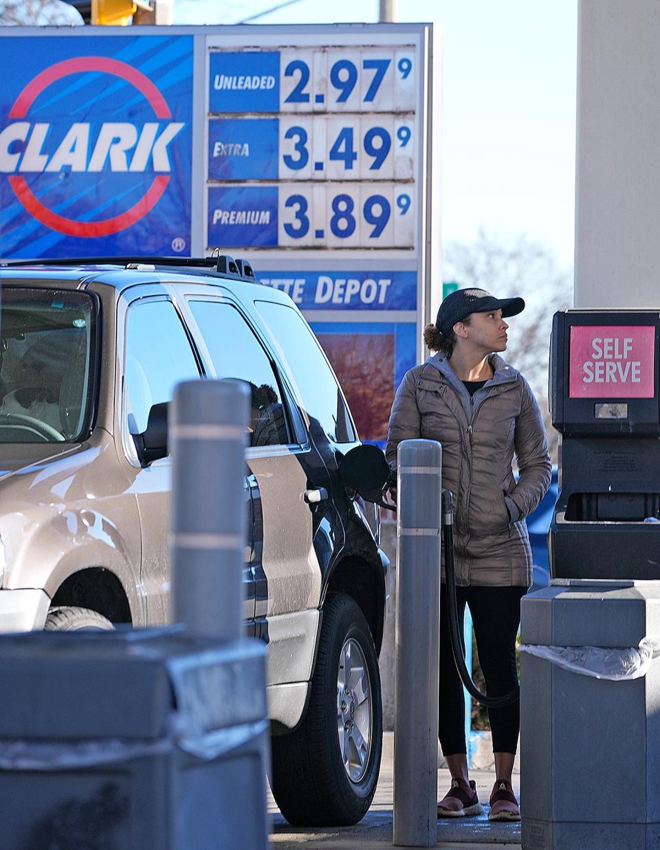 Shanon Kuhagen of Milwaukee fills up for $2.97 a gallon at the Clark gas station on West Oklahoma Avenue at South 16th Street in Milwaukee on Monday. Tuesday's average gasoline price in the Milwaukee-Waukesha area is down to $3.10.