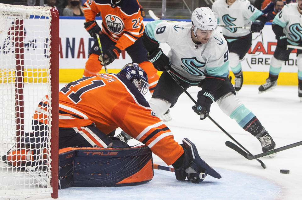 Edmonton Oilers goalie Mike Smith (41) makes the save on Seattle Kraken's Ryan Donato (9) during the first period of a preseason NHL hockey game in Edmonton, Alberta, Tuesday, Sept. 28, 2021. (Jason Franson/The Canadian Press via AP)