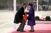 Netherlands' King Willem-Alexander bends down to kiss Britain's Queen Elizabeth II as she greets him upon his arrival to inspect an honour guard during a Ceremonial Welcome on Horse Guards Parade in London, Tuesday, Oct. 23, 2018. Dutch King Willem-Alexander and Queen Maxima are on a State Visit to Britain. (AP Photo/Matt Dunham, Pool)