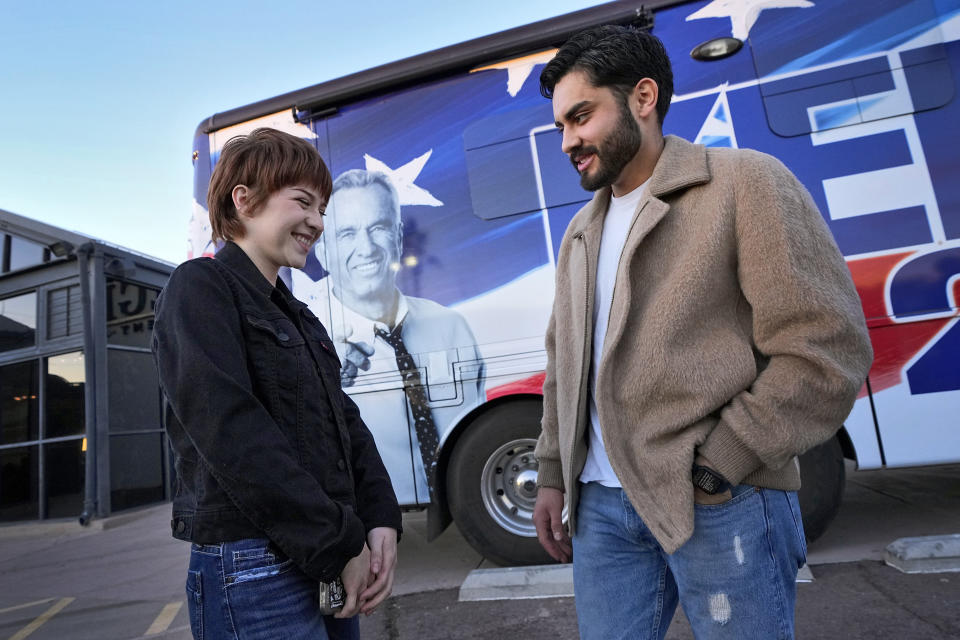 Daniela Conan and Michael Chacon wait in line to enter a voter rally for Independent presidential candidate Robert F. Kennedy Jr., Wednesday, Dec. 20, 2023, in Phoenix. (AP Photo/Matt York)