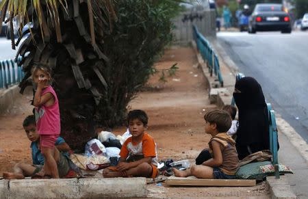 Homeless refugees from Syria rest by the side of a road in the capital Beirut July 22, 2013. REUTERS/Jamal Saidi