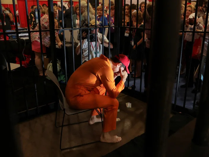 Brandon Straka, who founded #WalkAway and was convicted on charges linked to the January 6 attacks on the U.S. Capitol, wears prisoner clothes while demonstrating being jailed at the exhibition hall during the Conservative Political Action Conference (CPAC) in Dallas, Texas, U.S., August 5, 2022. REUTERS/Shelby Tauber