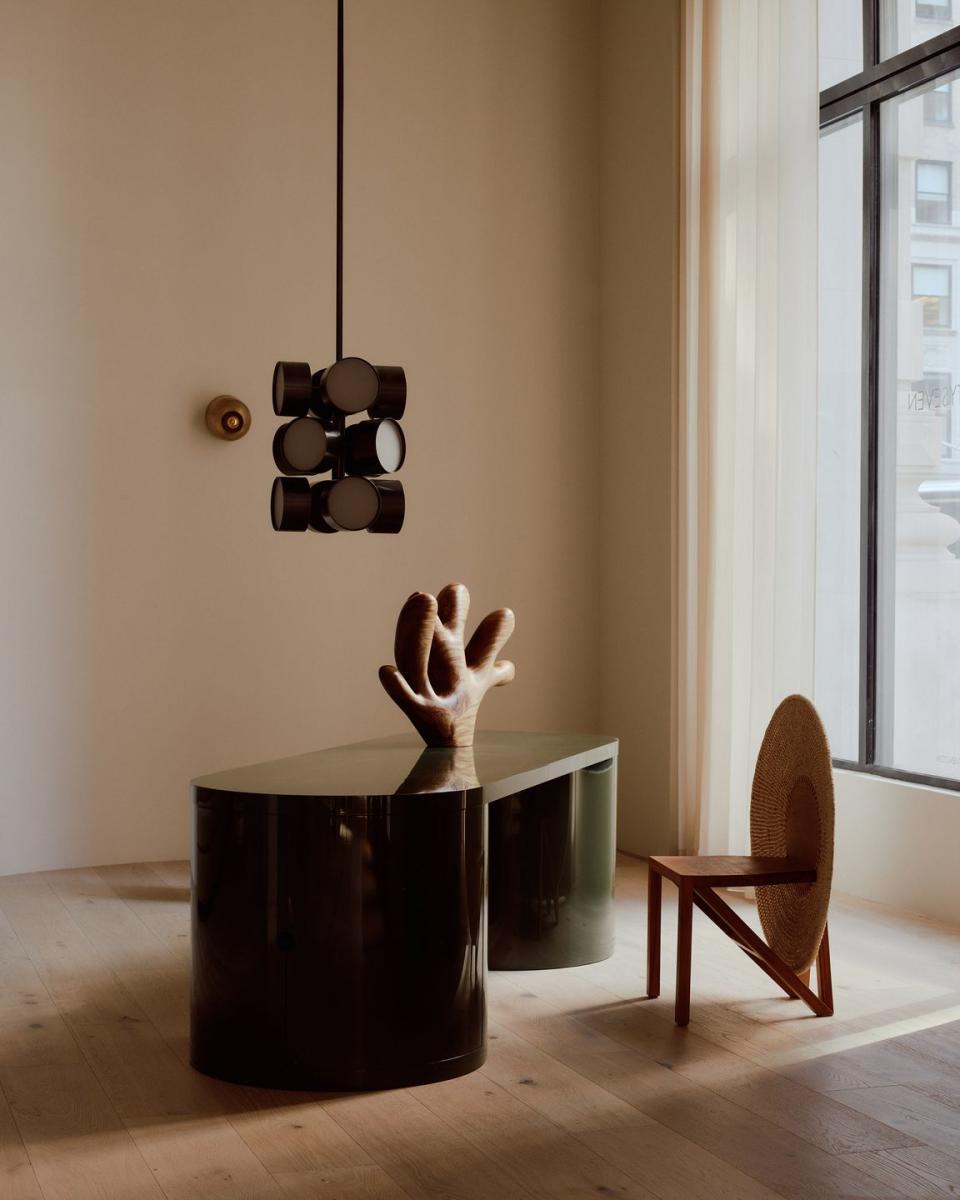 a wooden table with a chair and a lamp on it