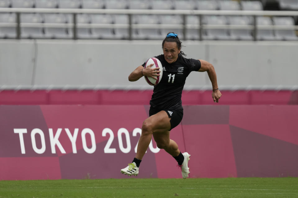 New Zealand's Portia Woodman runs to score a try in New Zealand's women's rugby sevens semifinal match against Fiji at the 2020 Summer Olympics, Saturday, July 31, 2021 in Tokyo, Japan. (AP Photo/Shuji Kajiyama)