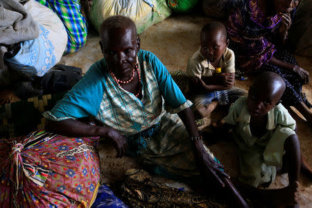 An elderly woman displaced by fighting in South Sudan rests by her belongings in Lamwo after fleeing fighting in Pajok town across the border in northern Uganda April 5, 2017. REUTERS/James Akena