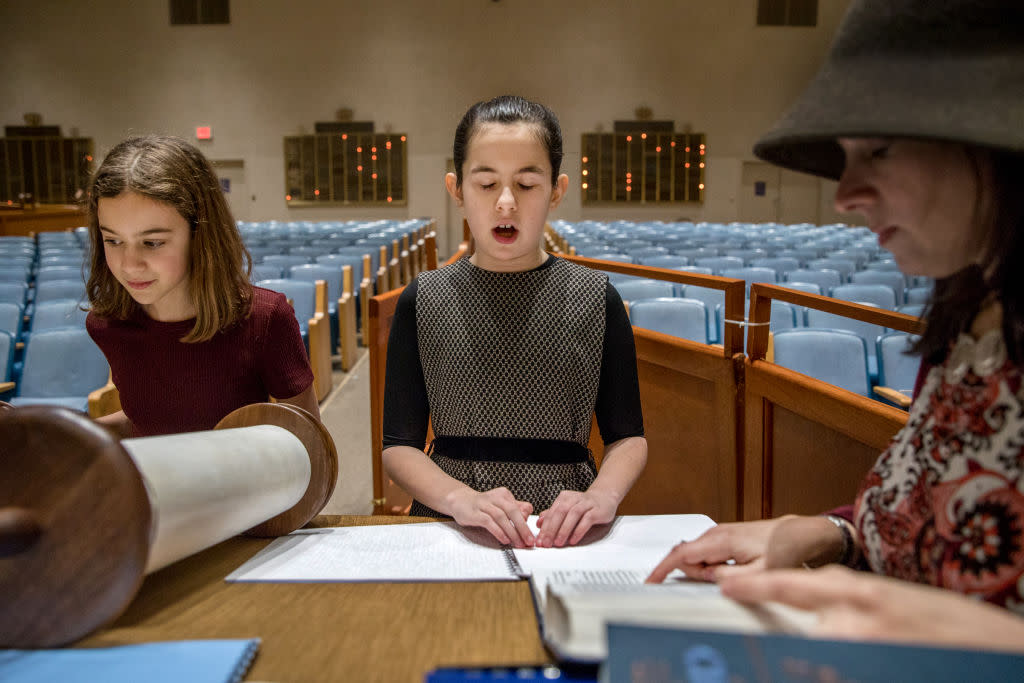 Illustrative. Batya Sperling Milner, who is blind, practices reading Torah with her aunt, Rachel Milner Gillers, and her friend Hannah Jaffee, during a rehearsal for her Bat-Mitzvah at Ohev Shalom synagogue in Washington, DC.