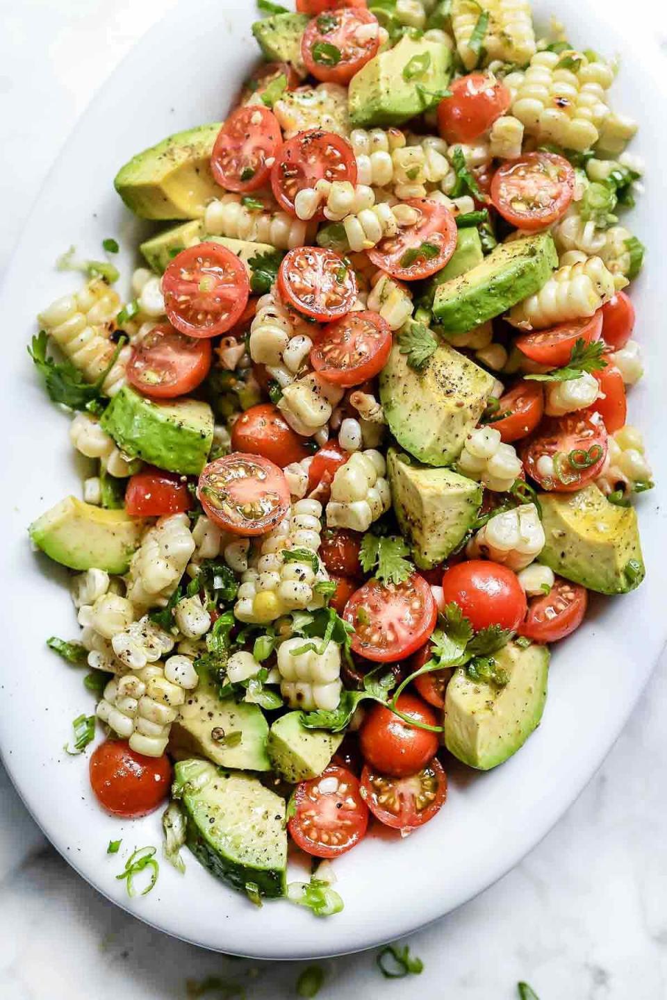 <strong>Get the&nbsp;<a href="https://www.foodiecrush.com/grilled-corn-tomato-avocado-salad/" target="_blank">Grilled Corn Salad with Tomato and Avocado</a>&nbsp;recipe from Foodie Crush</strong>